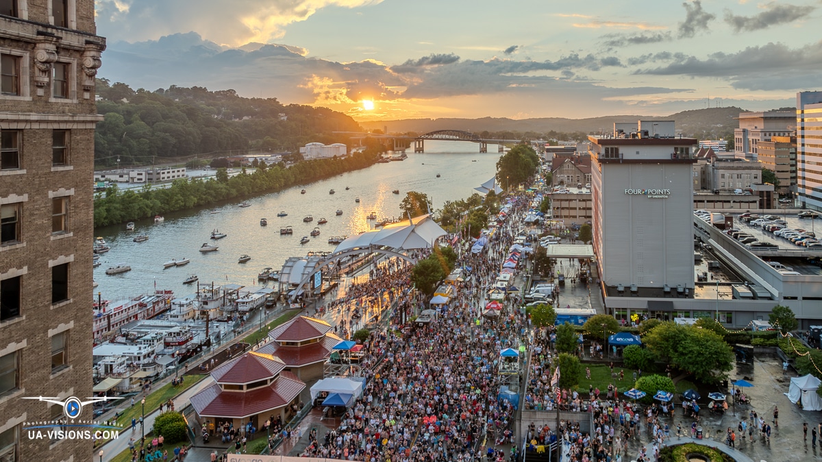 Sunset over the bustling Charleston Sternwheel Regatta with a crowd of attendees