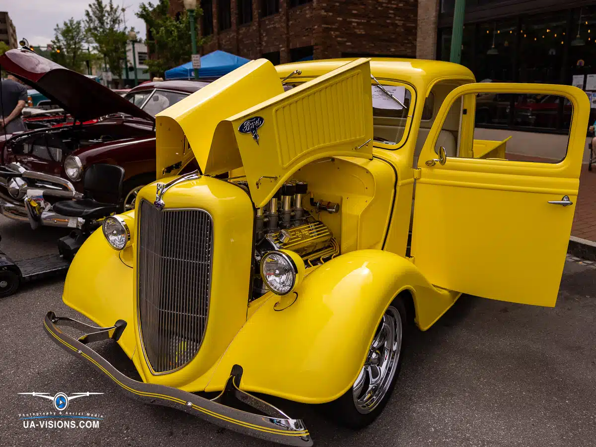 Classic cars, trucks, and a bustling atmosphere captured at a vibrant car show.
