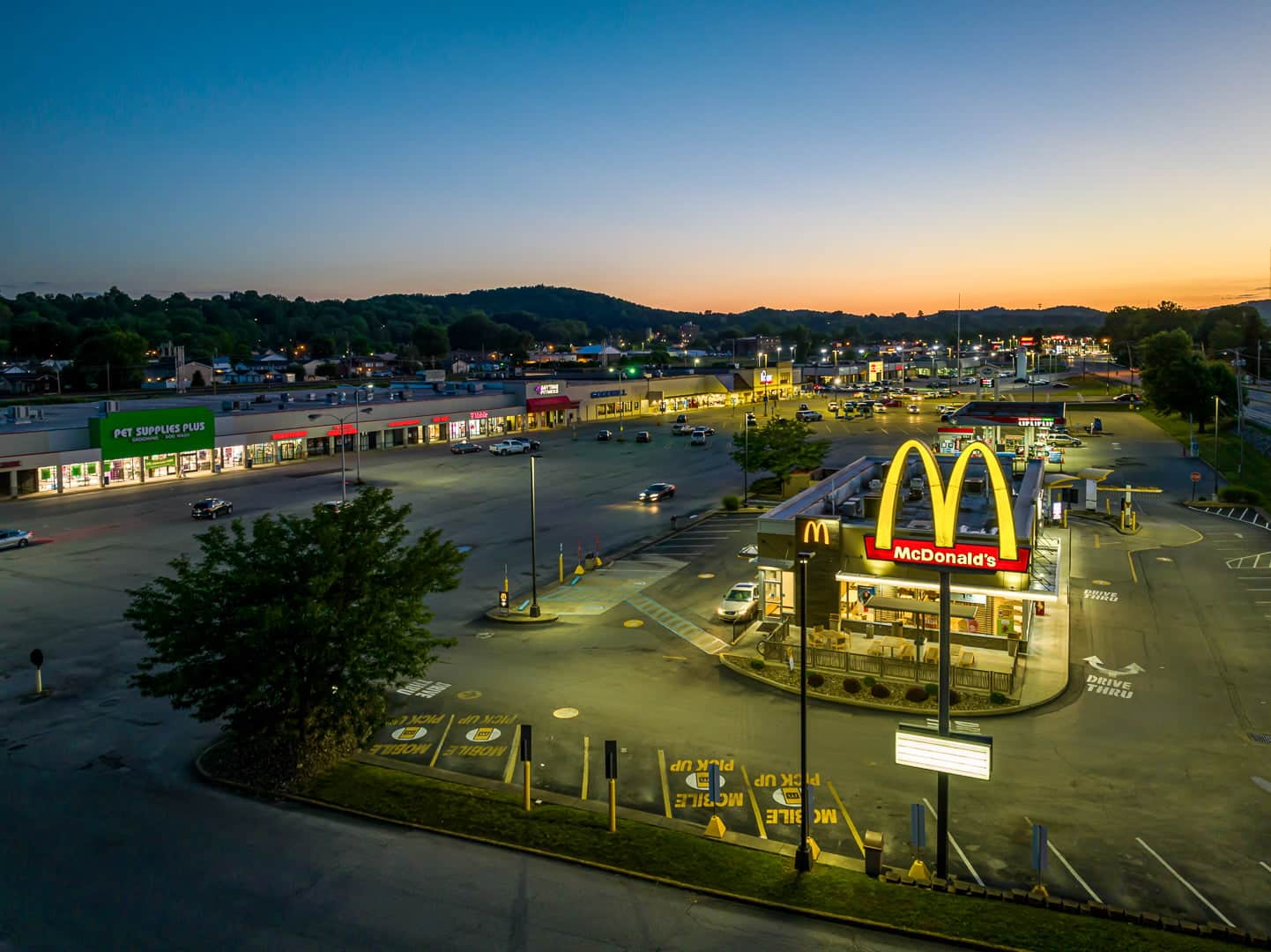 Aerial night view of a commercial district with illuminated McDonald's in St. Albans, WV.