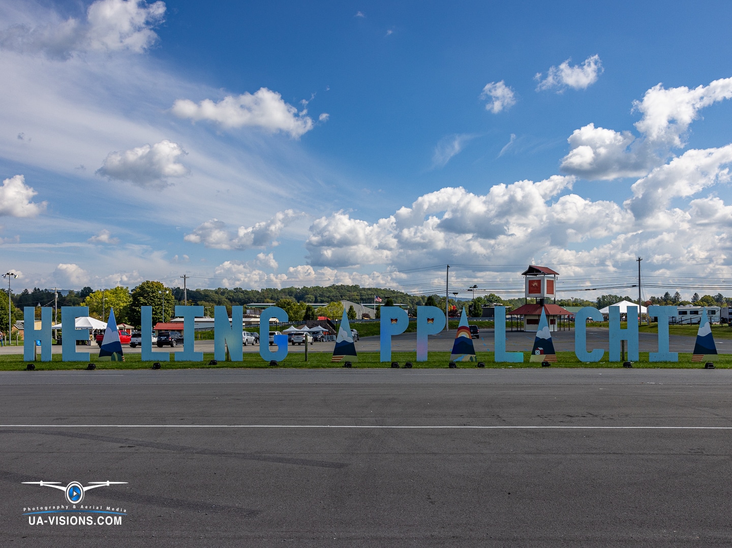 The 'Healing Appalachia' sign stands bold and bright against a blue sky in Lewisburg, WV.