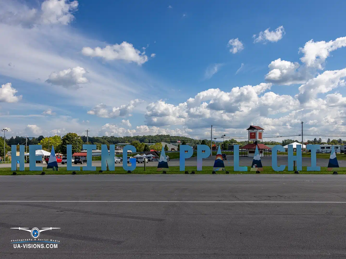 The 'Healing Appalachia' sign stands bold and bright against a blue sky in Lewisburg, WV.