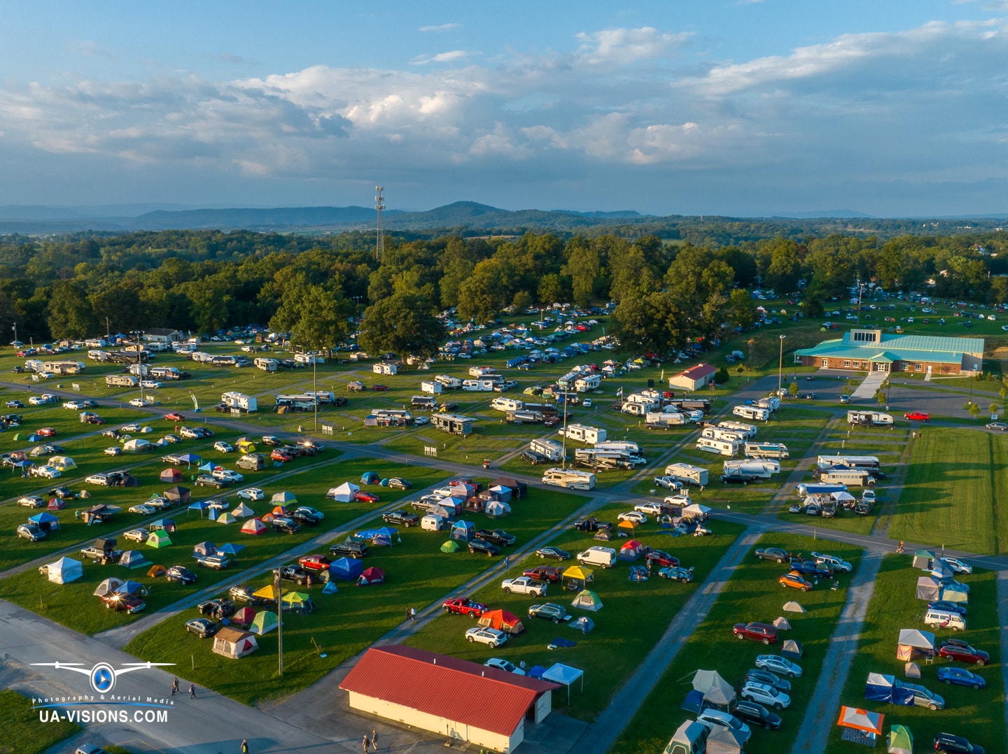 Aerial shot of the Healing Appalachia festival, a patchwork of tents and nature in harmony.