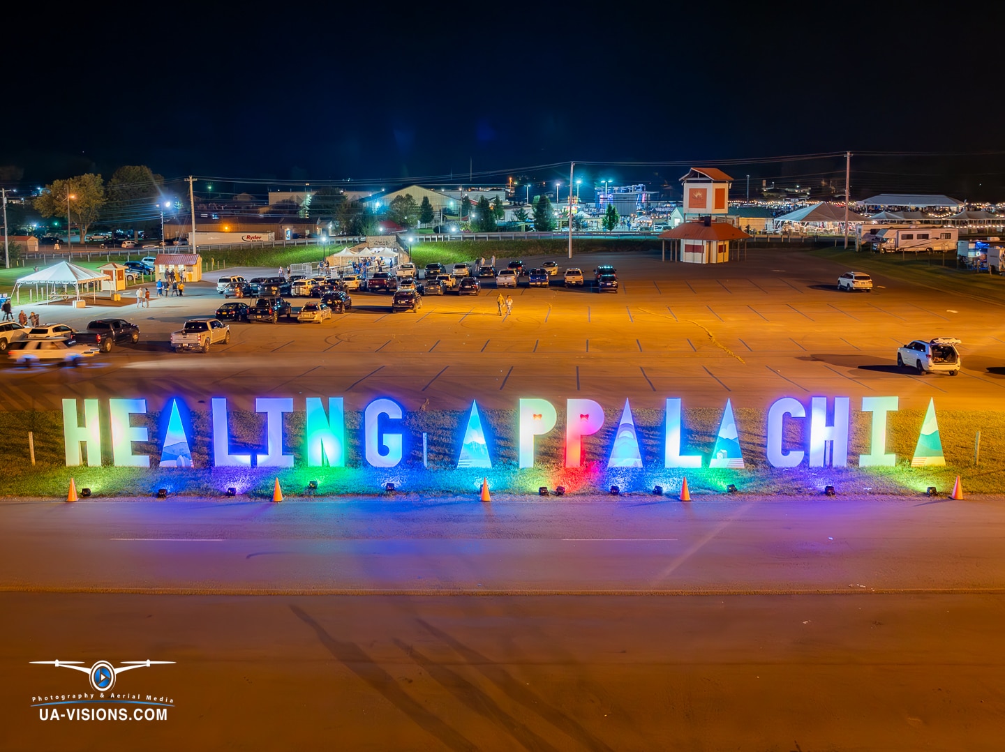 Night view of Healing Appalachia sign illuminated in colorful lights.