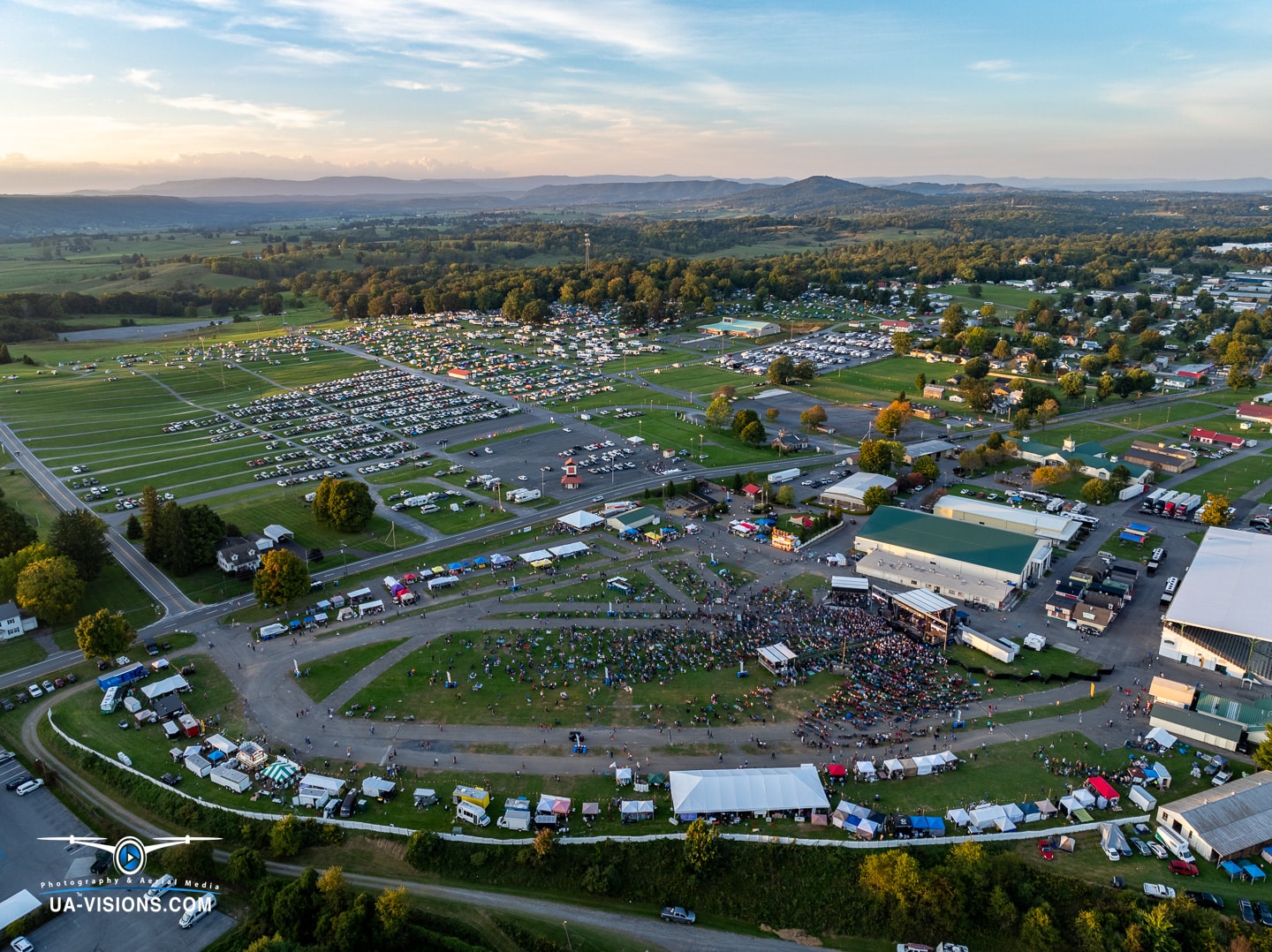 Aerial view of Healing Appalachia as twilight hugs the hills and the festival lights up.