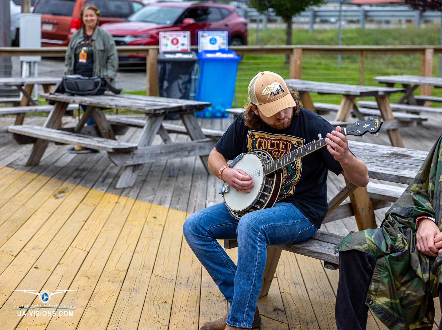 A banjo player finds his rhythm on a wooden deck at Healing Appalachia, the sound echoing tradition.