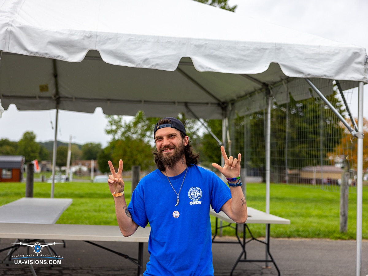 Volunteer flashing a peace sign, embodying the friendly spirit of Healing Appalachia.