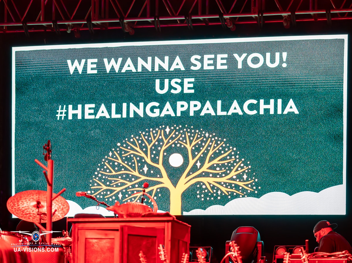Large display screen at Healing Appalachia urging community engagement with the hashtag #HealingAppalachia.