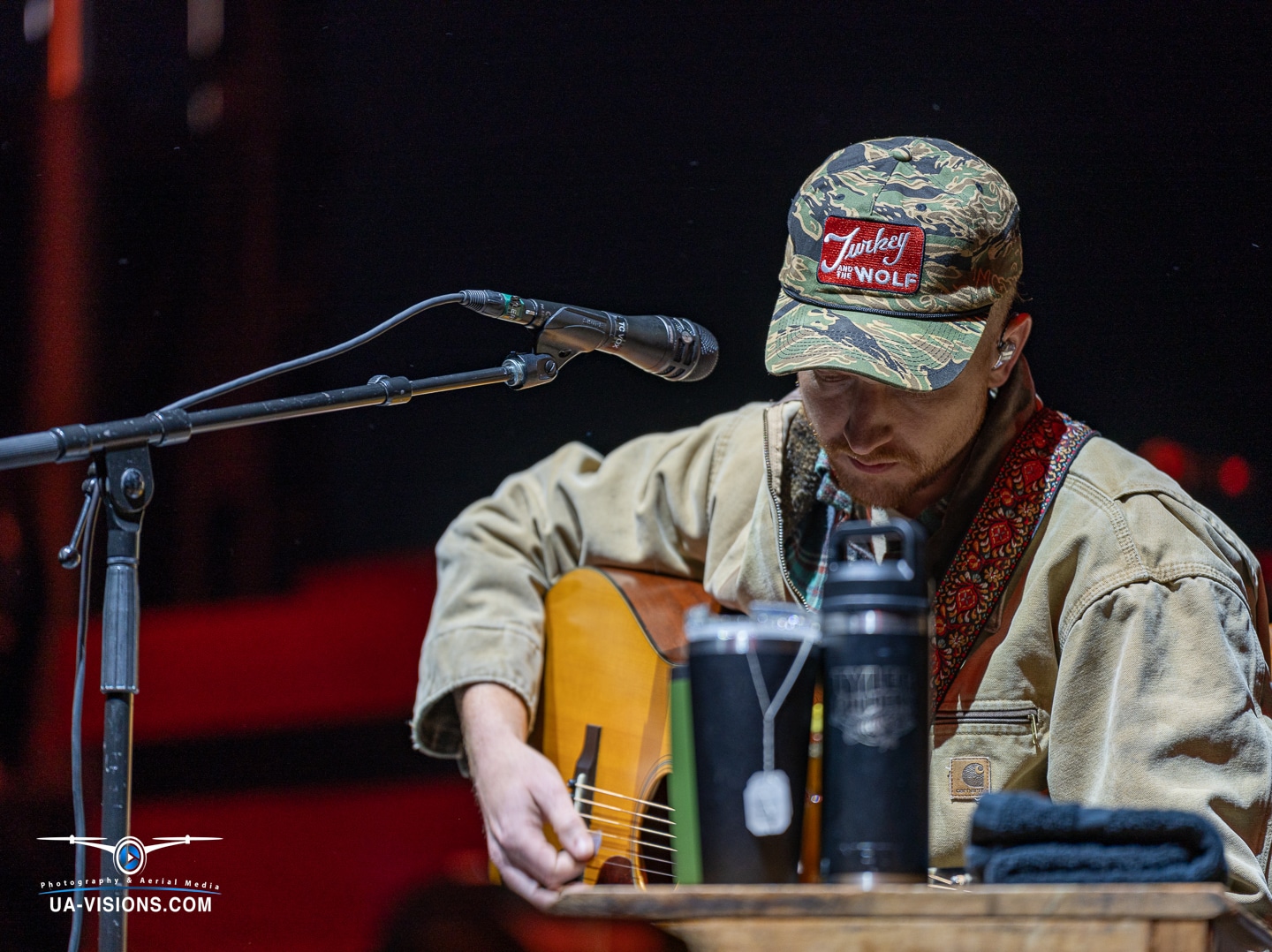 Close-up of Tyler Childers hands expertly playing the guitar, with each note echoing the spirit of the festival.
