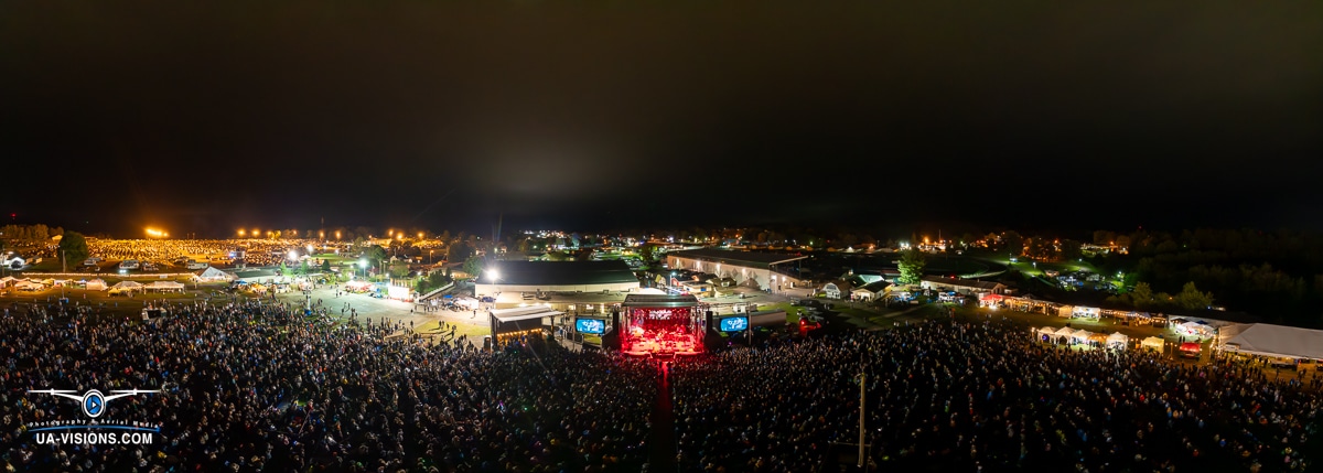 Panoramic night view of a large outdoor music festival crowd at Healing Appalachia.
