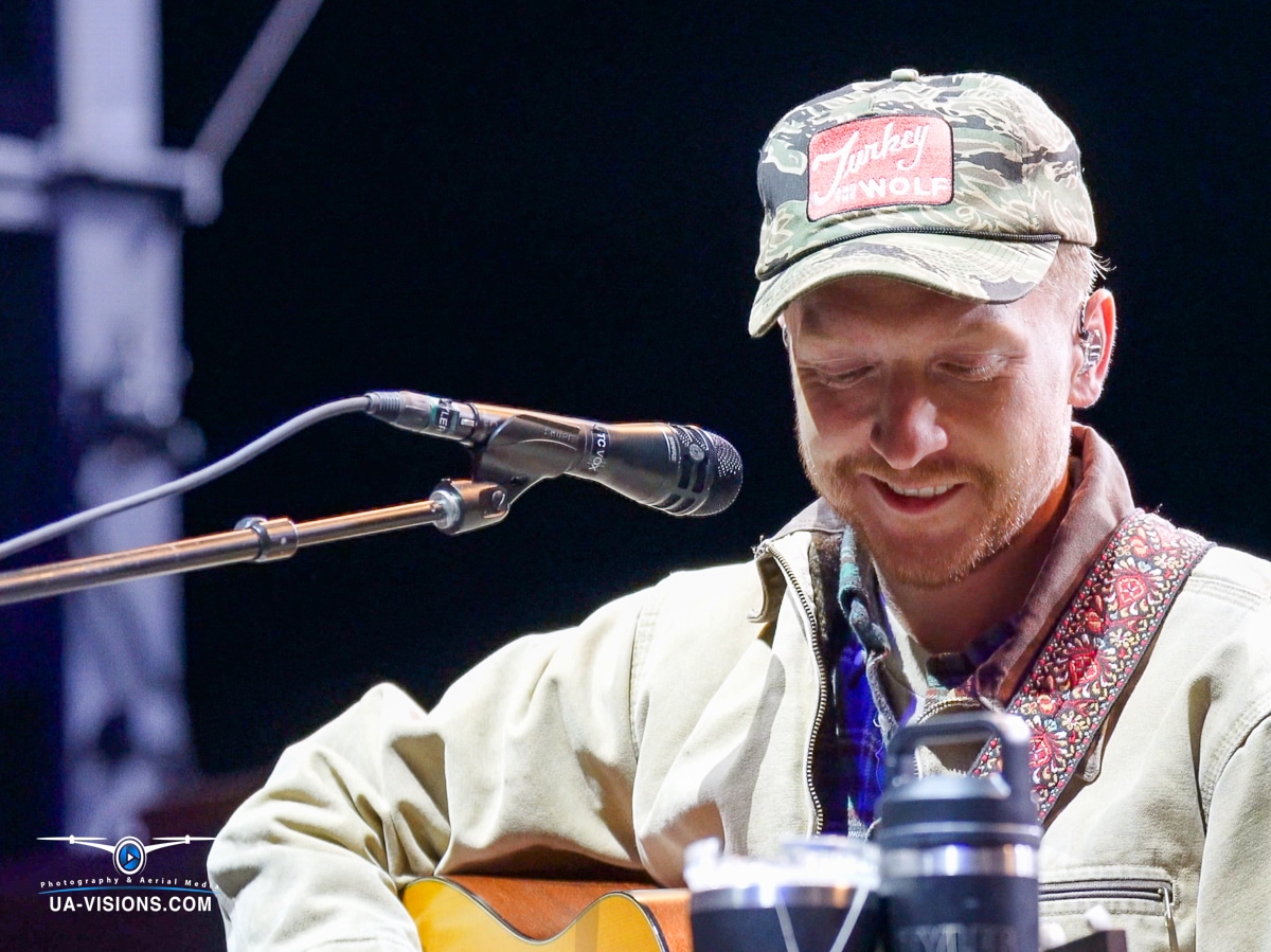 Close-up of Tyler Childers smiling while performing at Healing Appalachia.