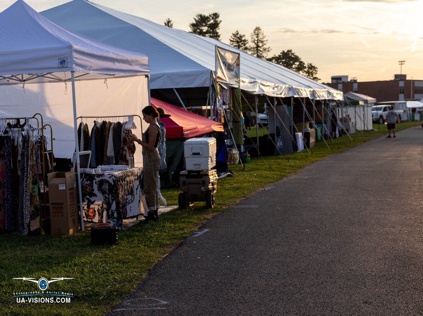 Twilight hustle along the vendor row at Healing Appalachia, where every tent has a tale.