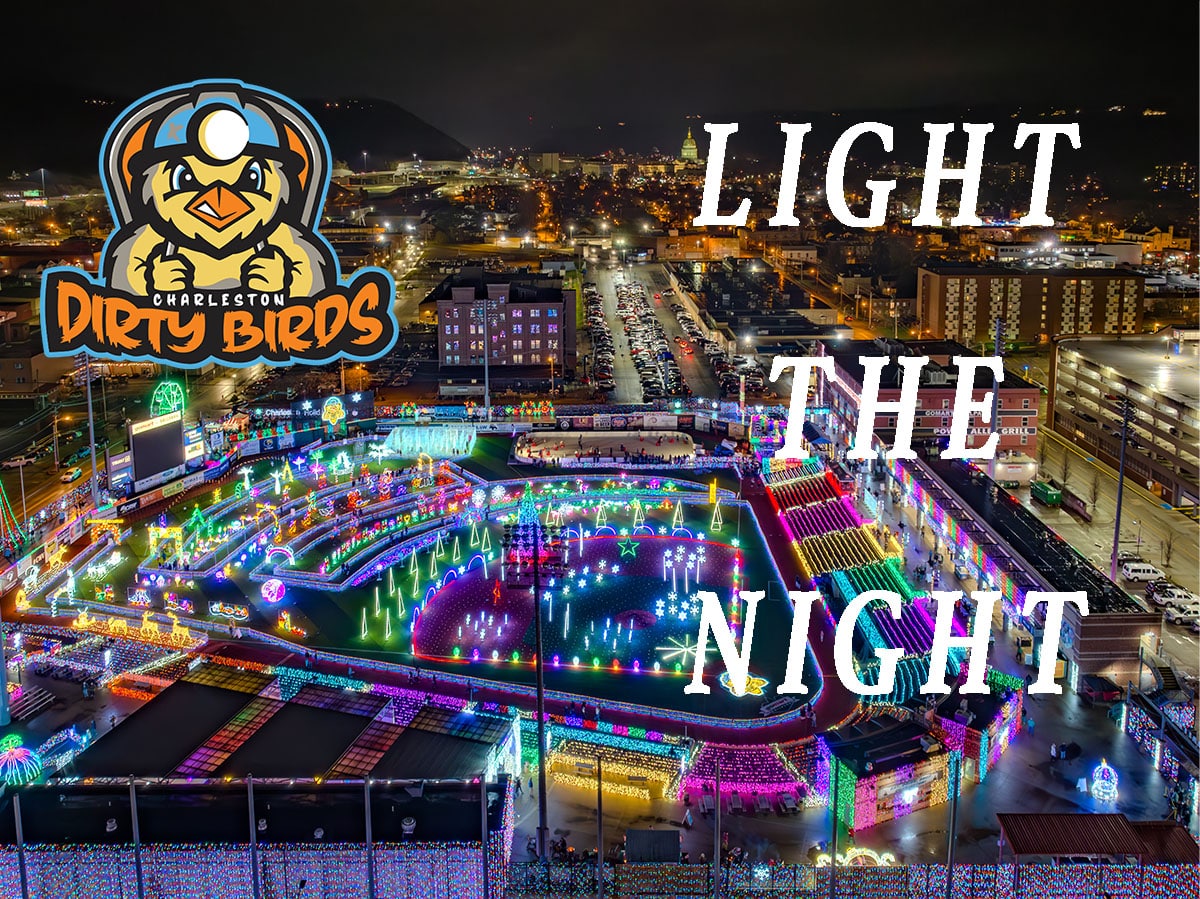 Aerial view of Charleston Dirty Birds stadium illuminated by colorful holiday lights for Light the Night event.
