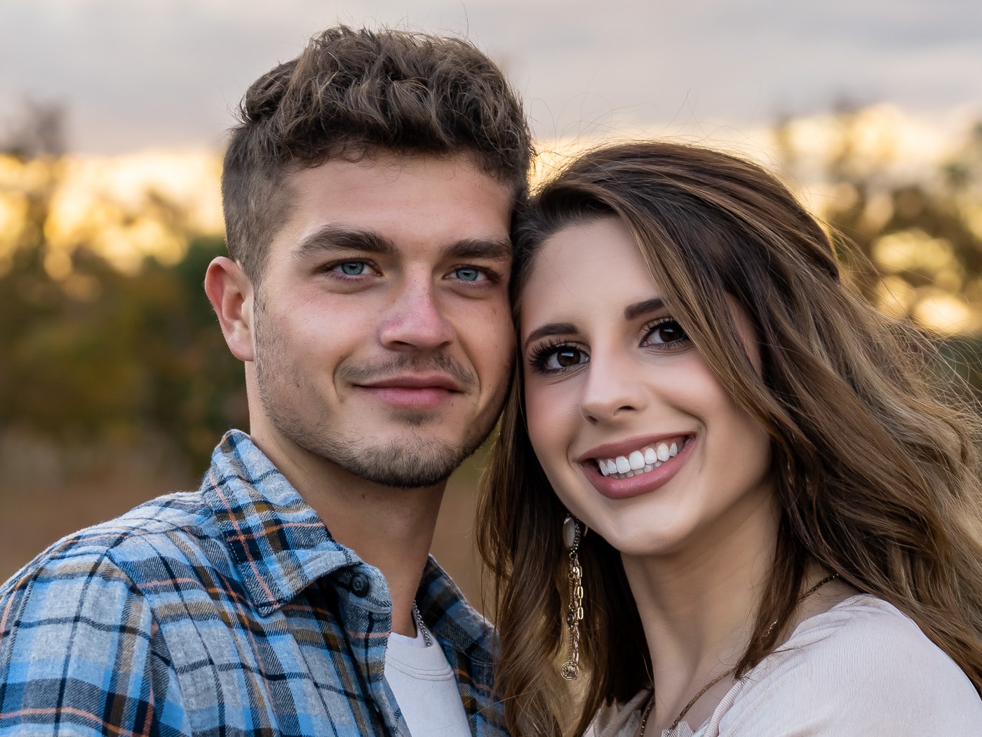 Close-up of Logan and Kaitlyn smiling, deeply in love during their engagement session.