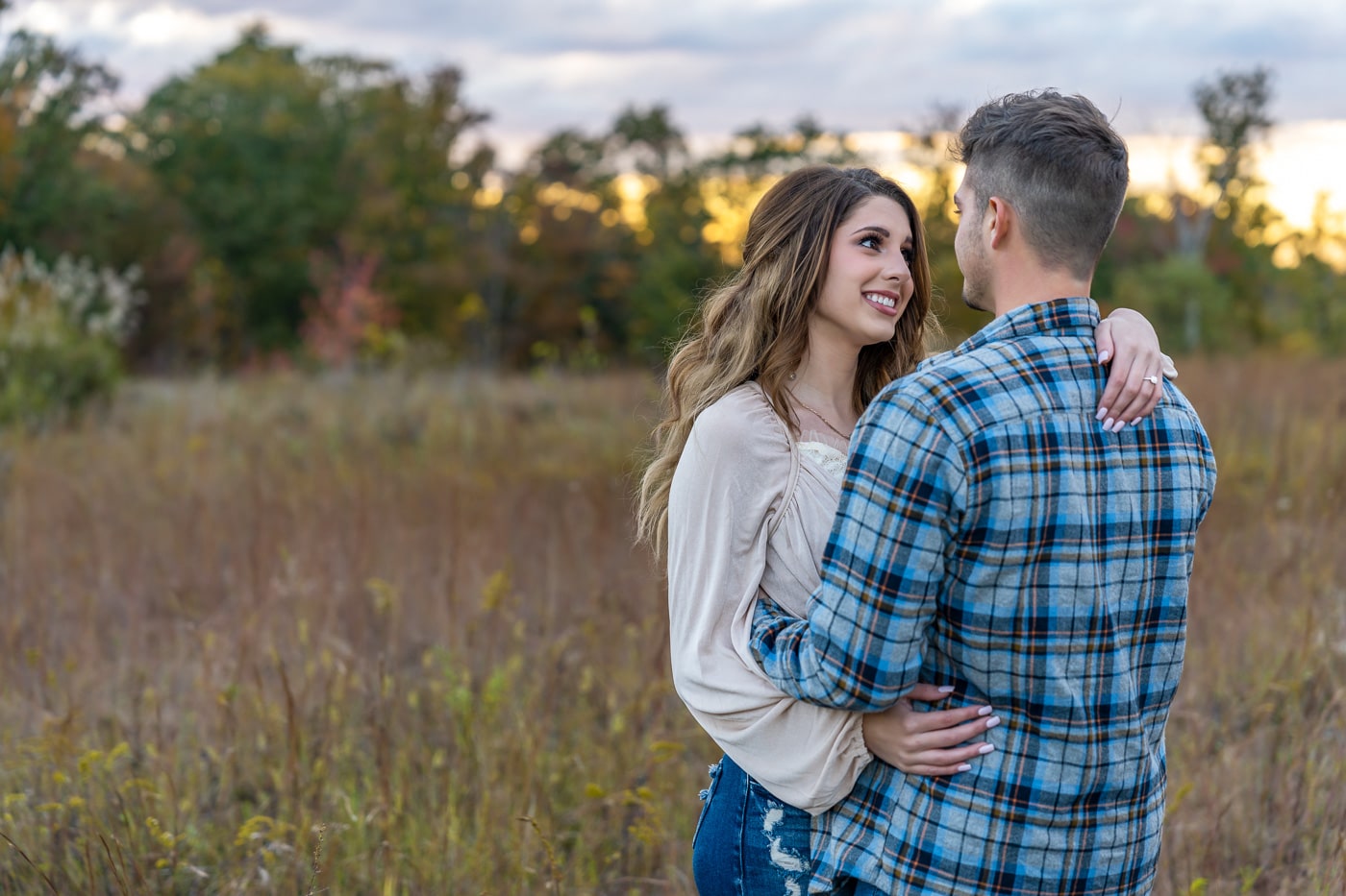 Close-up of Logan and Kaitlyn smiling, deeply in love during their engagement session.