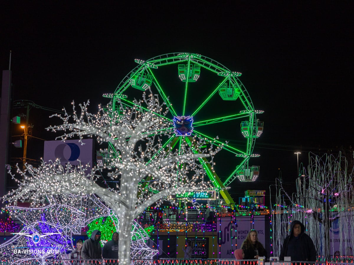 A winter's tale told in lights, this image by UA-Visions features a Ferris wheel turning amidst a snowy landscape, captured at Charleston's Light the Night event. It's a snapshot of joy, perfect for sharing the holiday spirit.