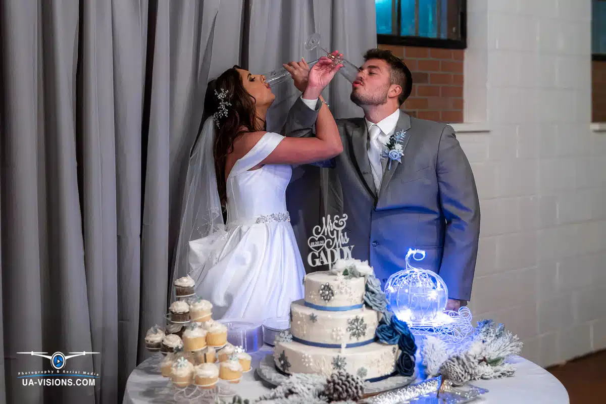Katilyn and Logan Gaddy cutting their wedding cake, captured by UA-Visions.