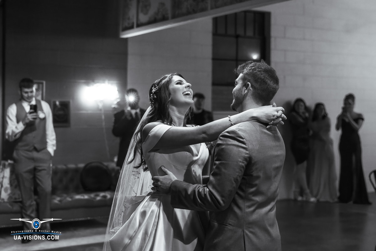 Black and white image of Katilyn and Logan Gaddy dancing at their reception.