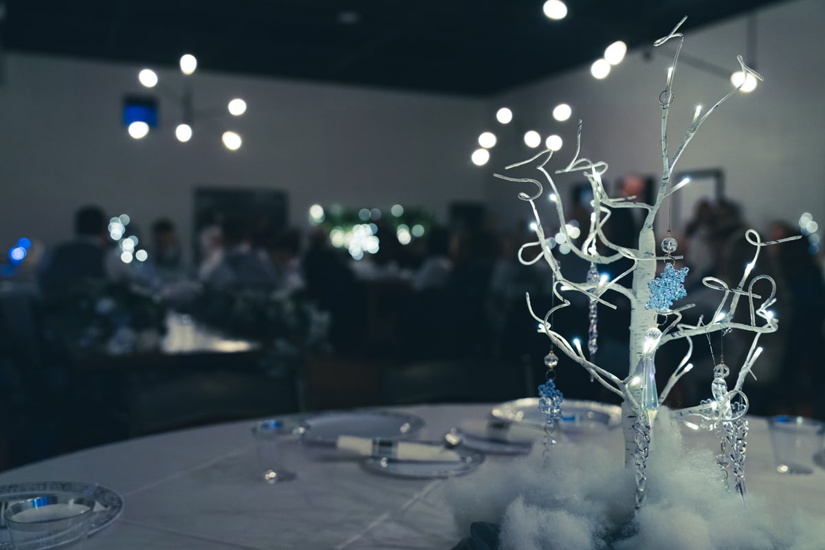 white tree centerpiece with hanging crystals at a winter wedding.