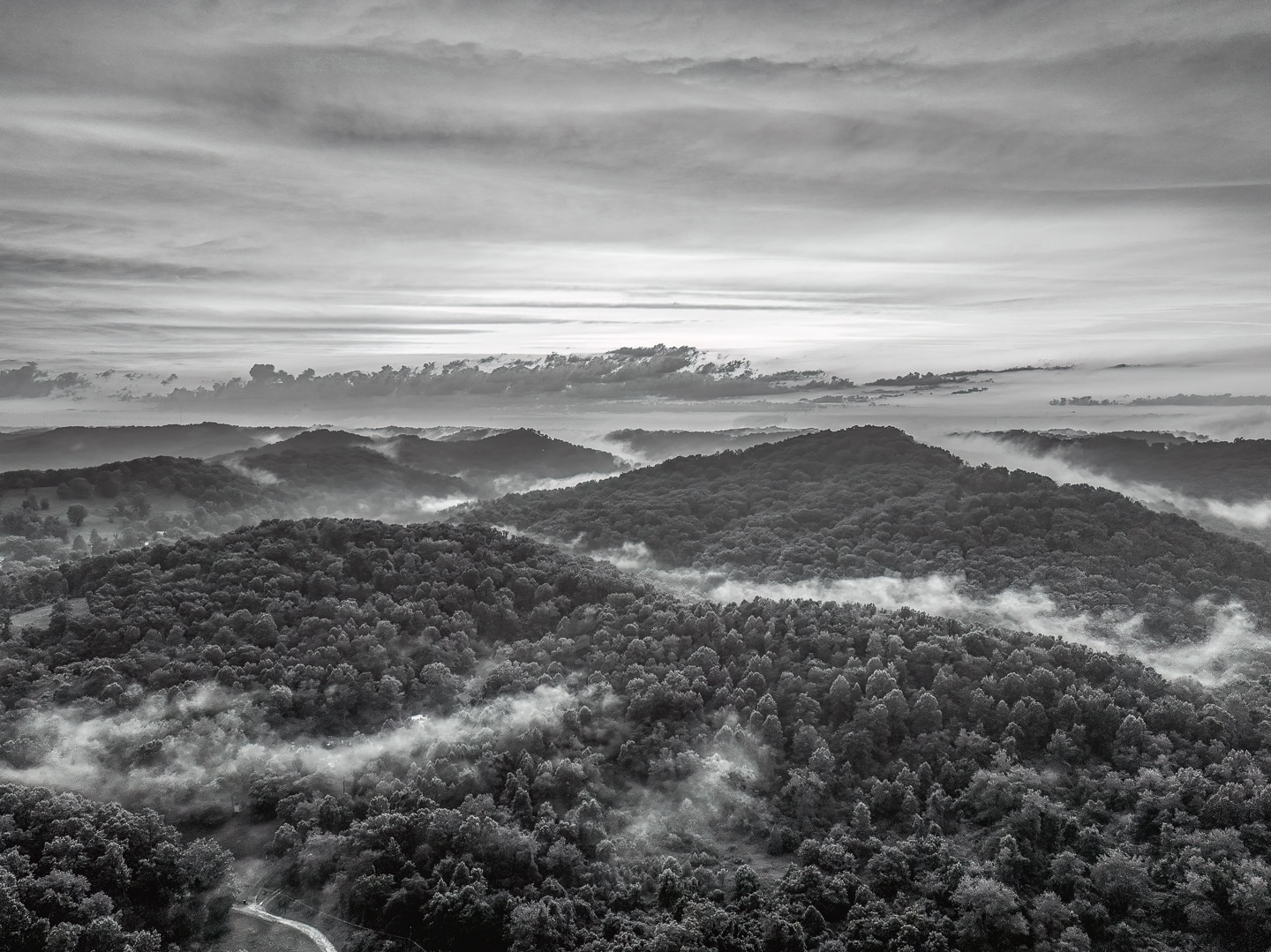An aerial photo of the fog rolling through the appalachian mountains after a summer storm