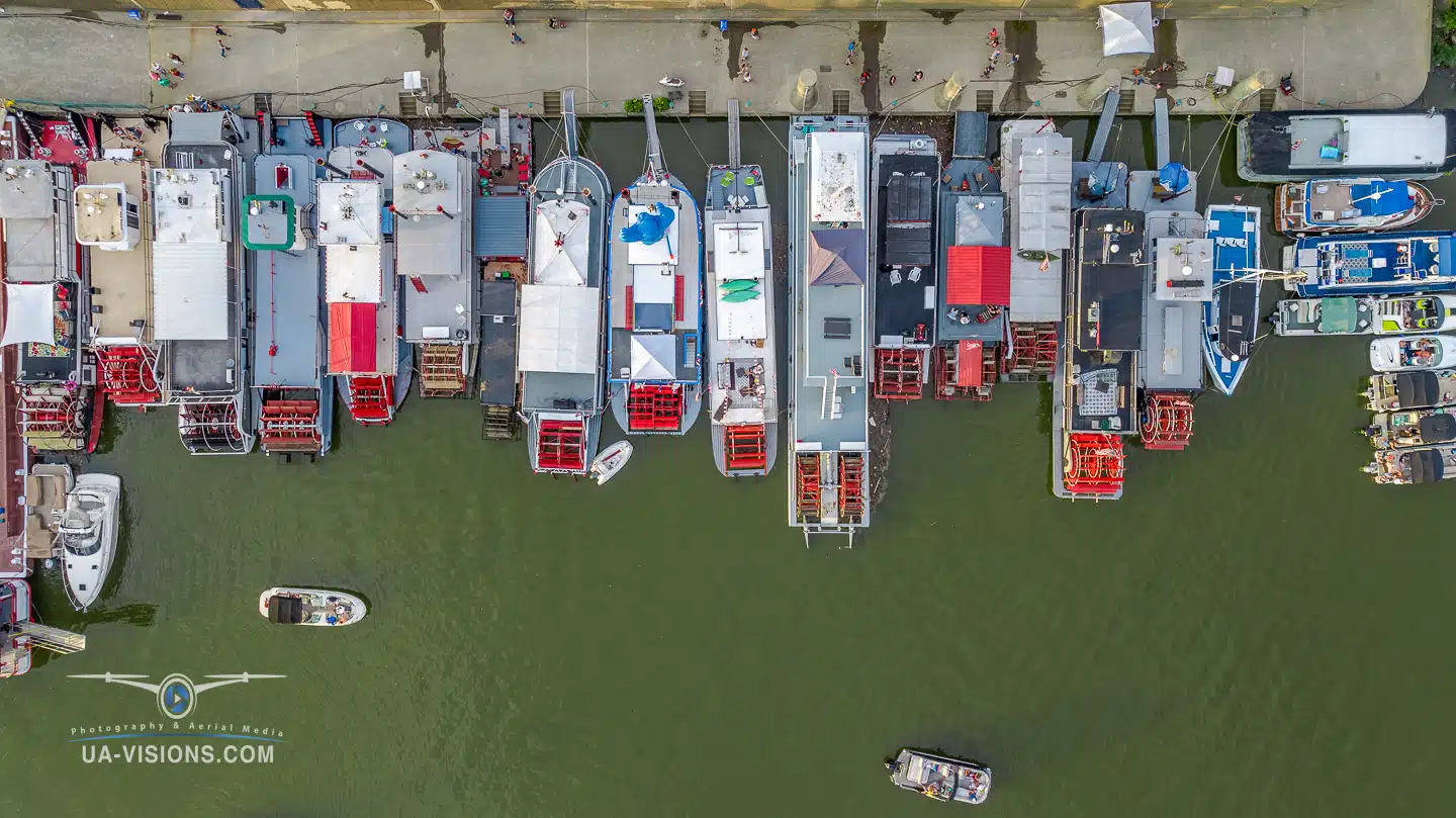 An aerial view of several sternwheel boats docked along Haddad Riverfront Park in Charleston, WV during the Charleston Sternwheel Regatta.